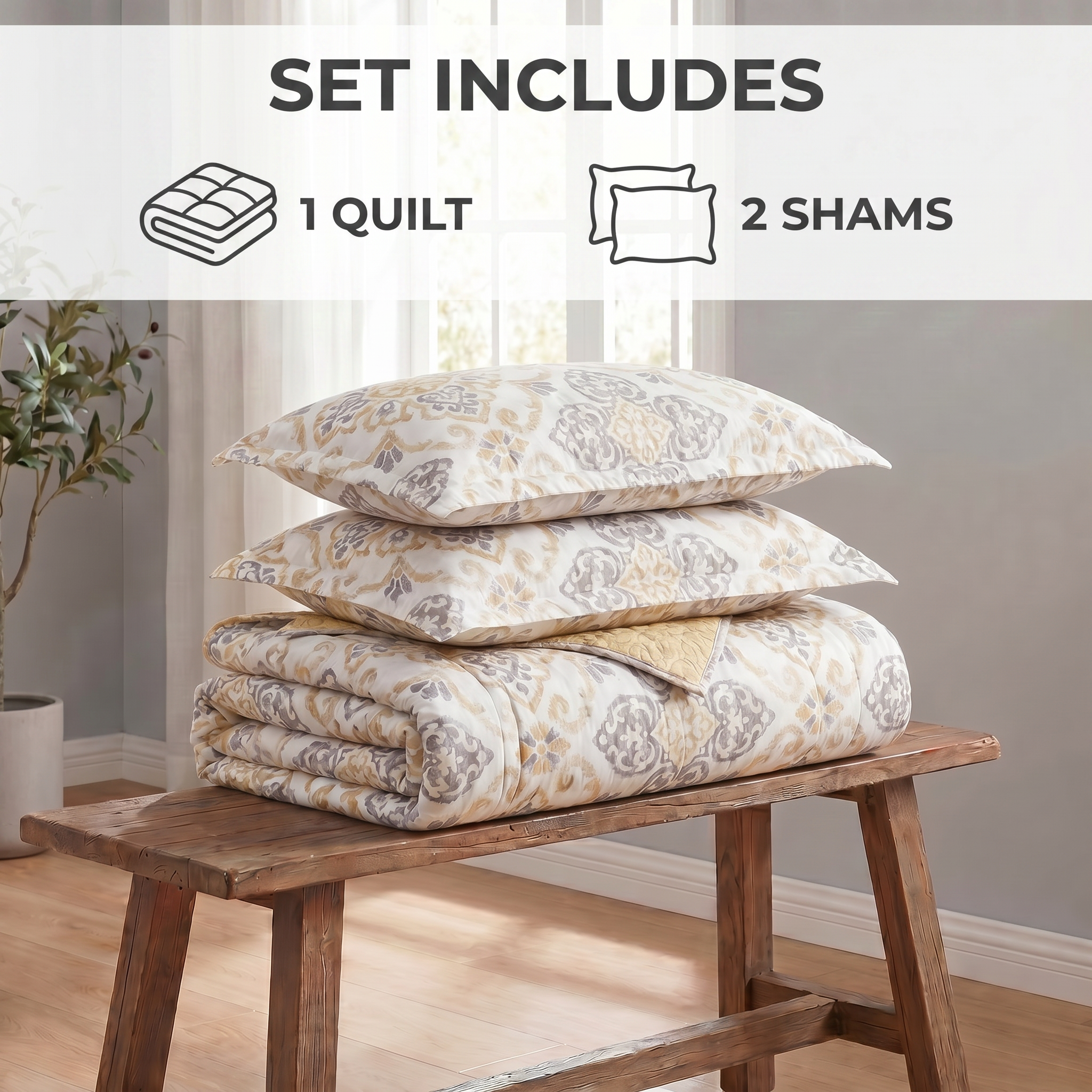 Set of quilt and shams on a wooden bench with room in the background