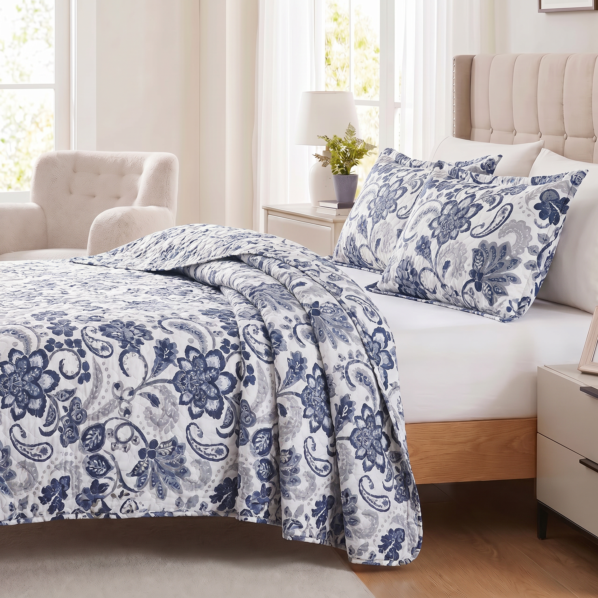 Bedroom with floral bedding and white furniture