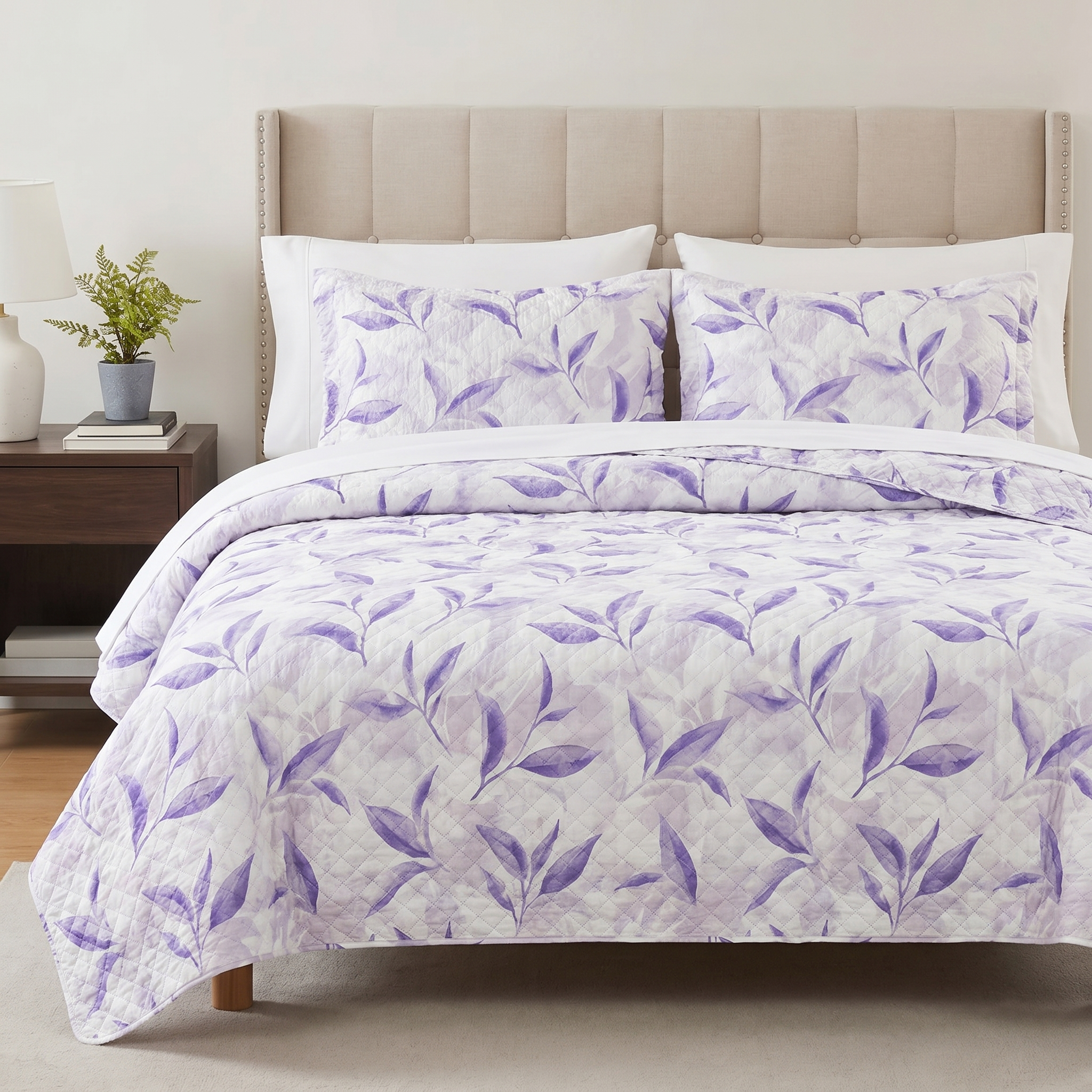 Bed with purple leaf patterned bedding and beige headboard