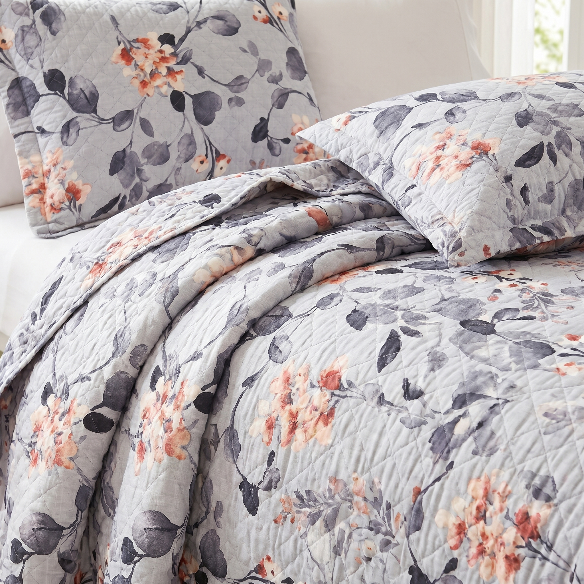 Floral patterned quilt and pillow set on a bed