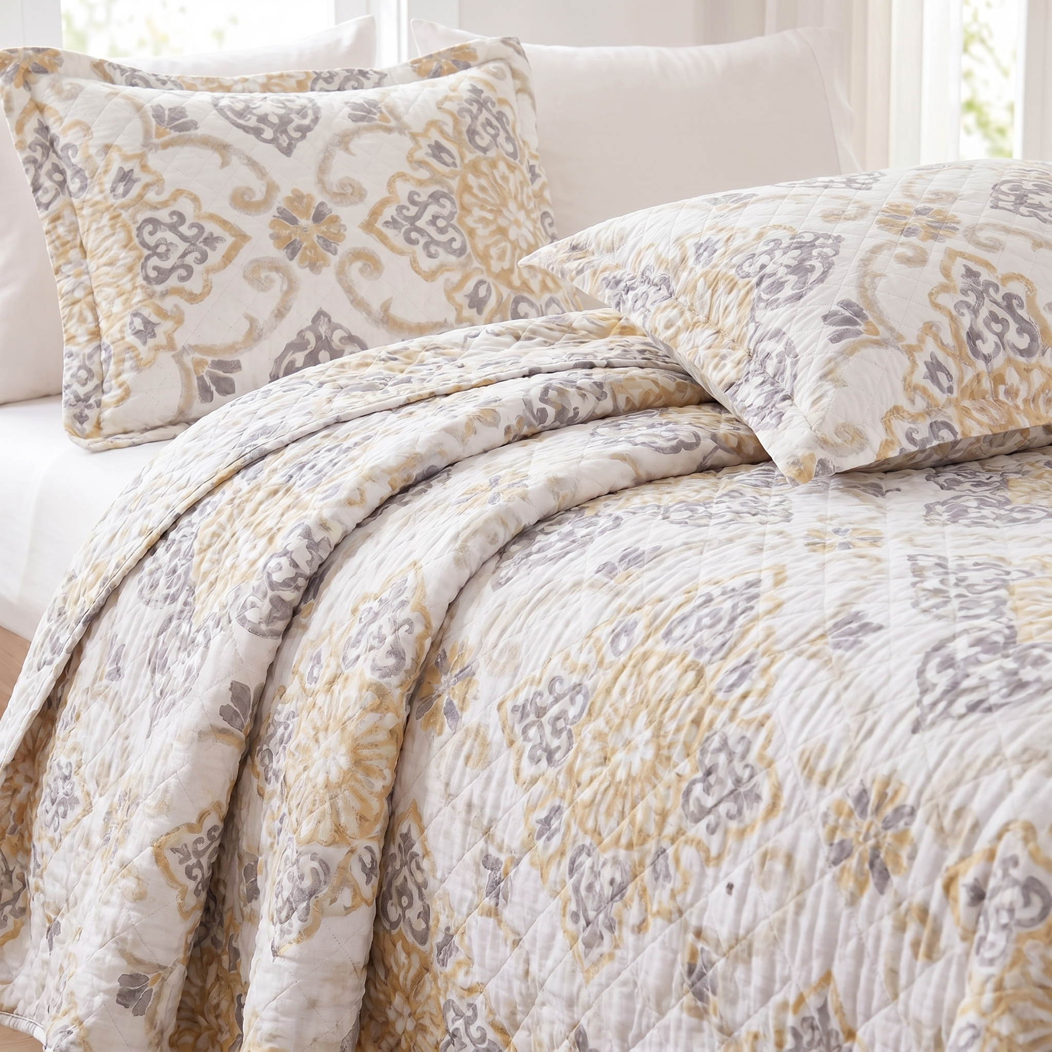 Floral patterned quilt and pillow on a bed