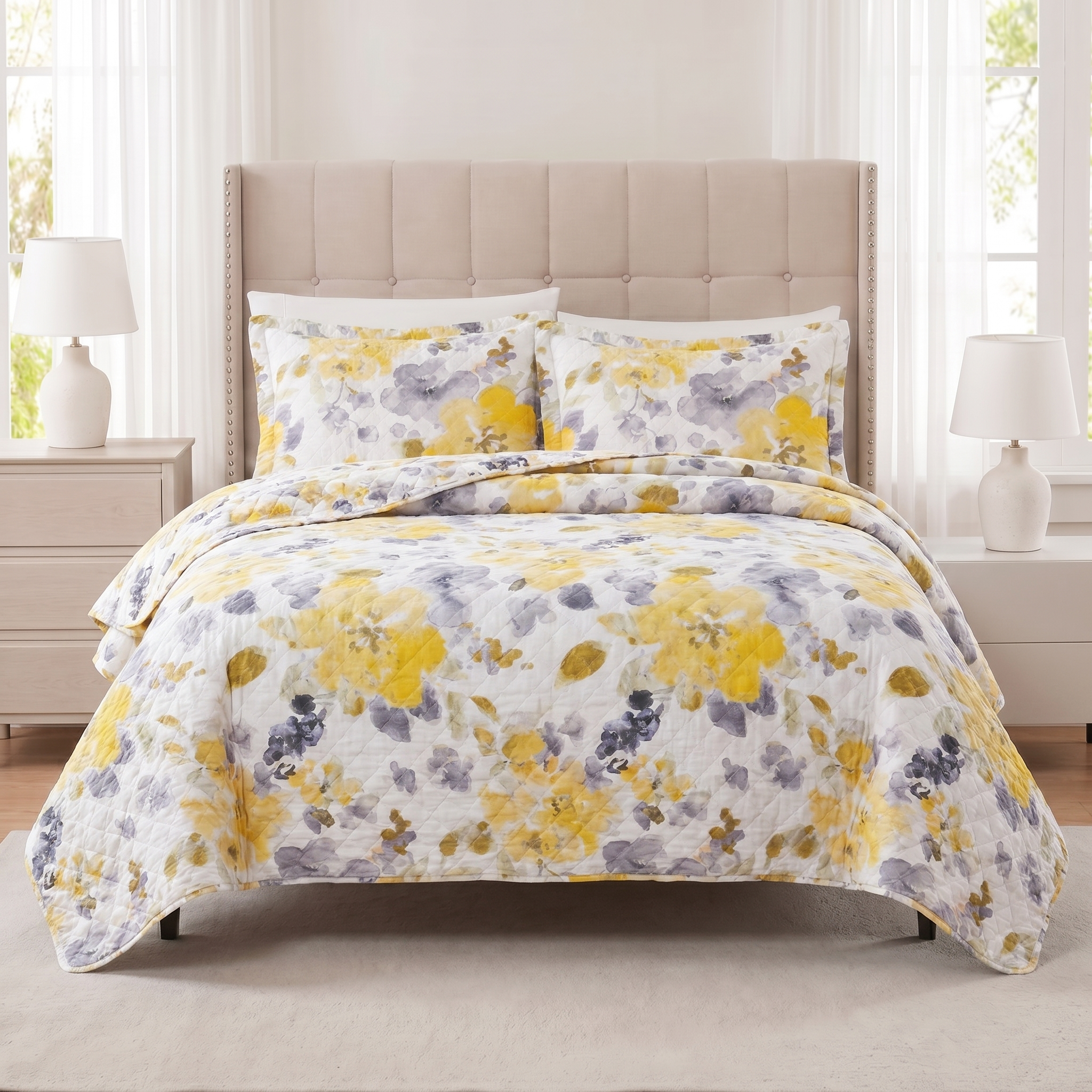 Floral patterned comforter set on a bed in a bright bedroom.