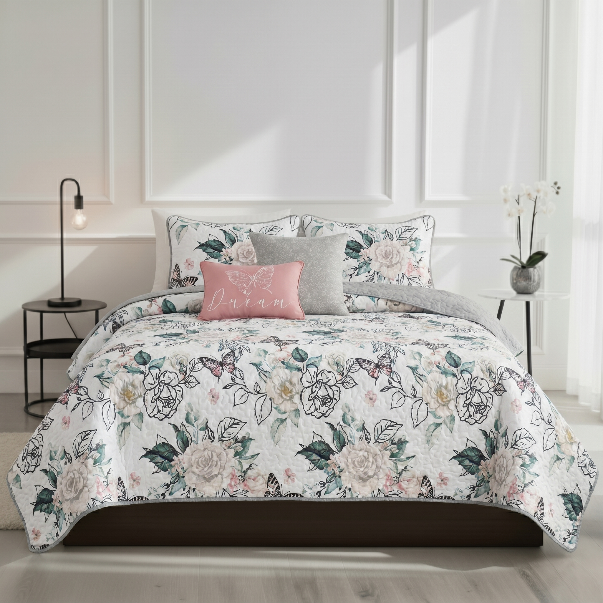 Floral bedding set on a bed with matching pillows in a bedroom setting.