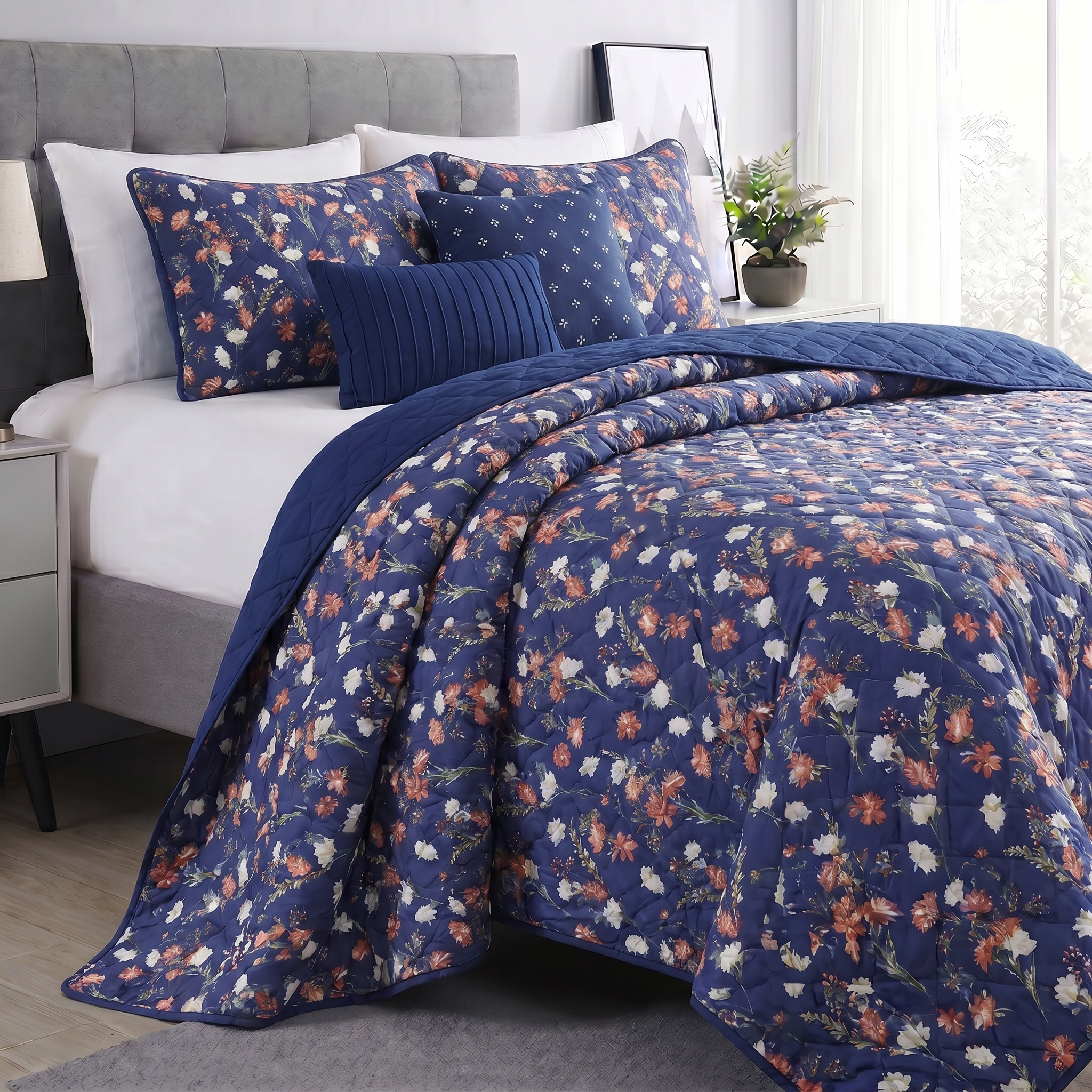 Floral patterned comforter on a bed in a bedroom setting